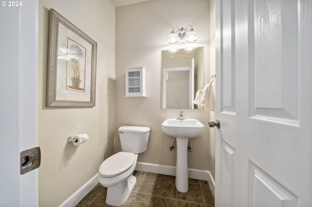 bathroom with toilet and tile patterned flooring