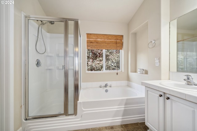 bathroom featuring vanity and shower with separate bathtub