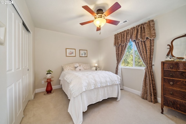 carpeted bedroom featuring a closet and ceiling fan