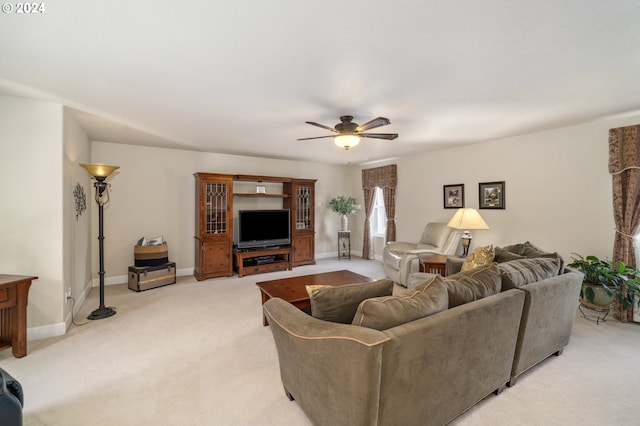 carpeted living room with ceiling fan