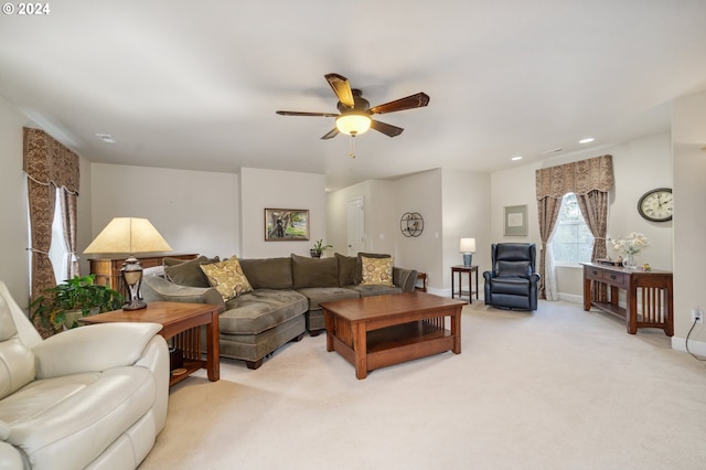 carpeted living room with ceiling fan