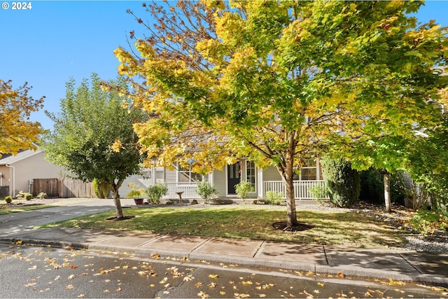 obstructed view of property featuring a front yard