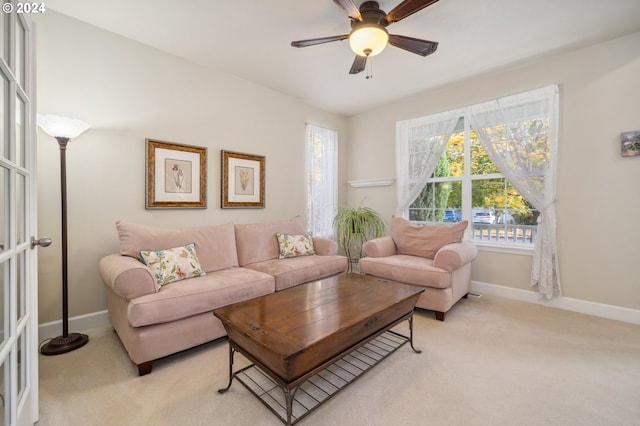 carpeted living room with ceiling fan