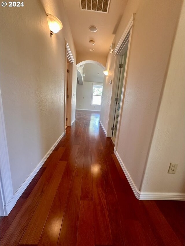 corridor featuring dark hardwood / wood-style floors