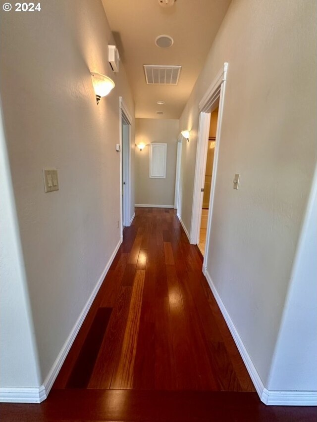 hallway with dark hardwood / wood-style flooring