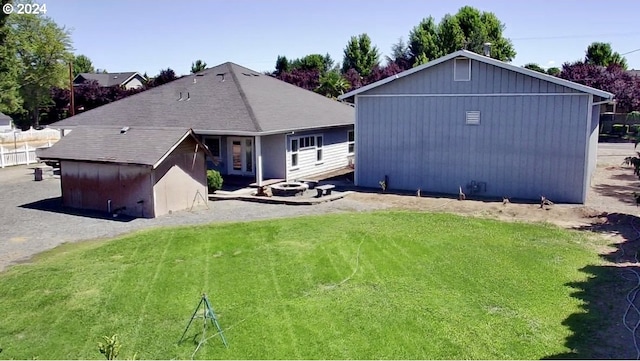 back of house with a lawn