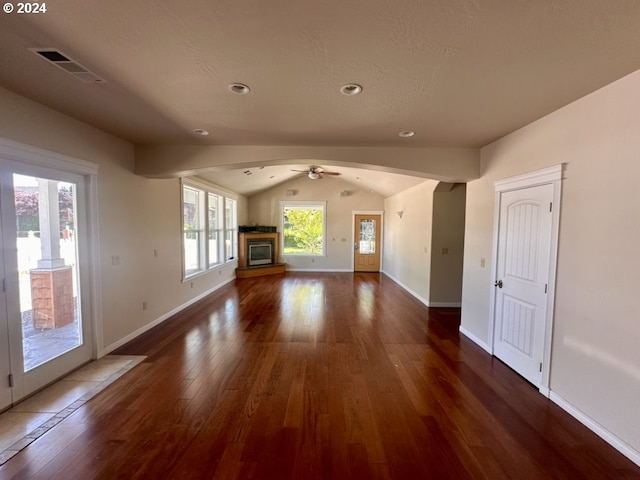 unfurnished living room featuring ceiling fan, lofted ceiling, a textured ceiling, and dark hardwood / wood-style flooring