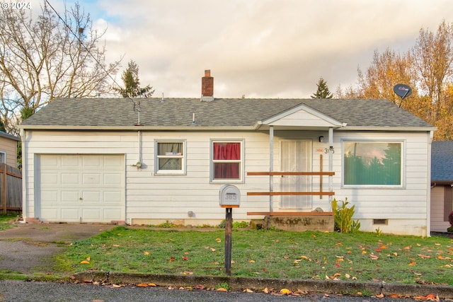 single story home featuring a front yard and a garage