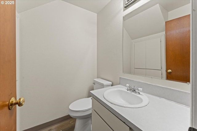 2427 SW 218th Dr, Beaverton, OR 97003 - half bathroom with toilet, vanity, wood finished floors, and baseboards