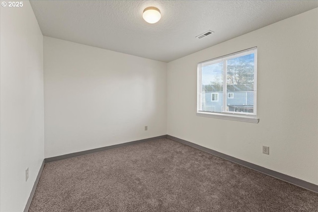 2427 SW 218th Dr, Beaverton, OR 97003 - carpeted spare room with a textured ceiling and baseboards