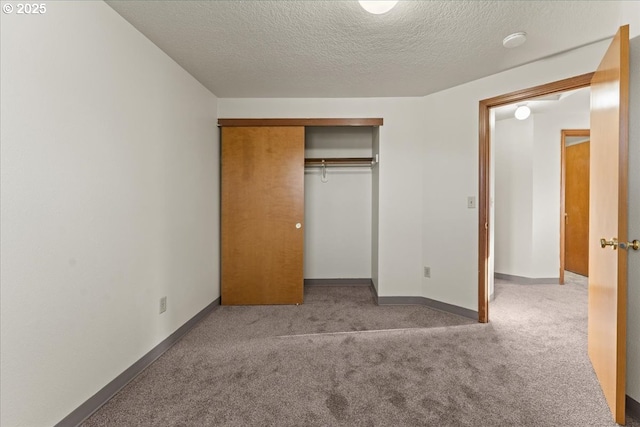 2427 SW 218th Dr, Beaverton, OR 97003 - unfurnished bedroom with carpet floors, a textured ceiling, a closet, and baseboards