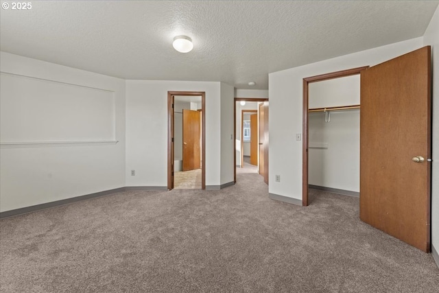 2427 SW 218th Dr, Beaverton, OR 97003 - unfurnished bedroom with carpet, a textured ceiling, a closet, a walk in closet, and baseboards