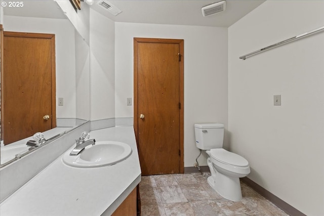 2427 SW 218th Dr, Beaverton, OR 97003 - bathroom with vanity, toilet, baseboards, and stone finish flooring