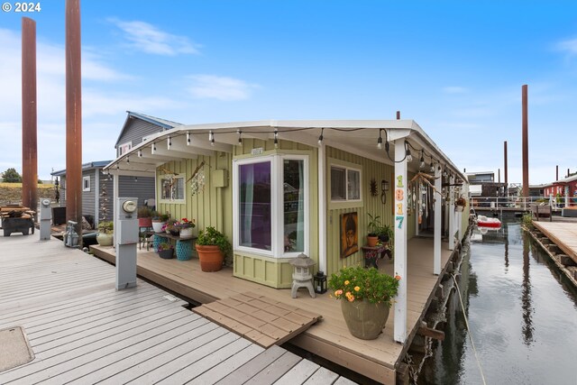 exterior space with a dock and a water view