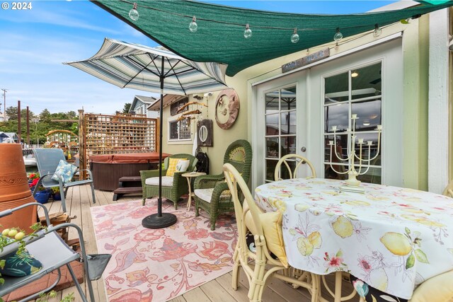 view of patio featuring french doors, a hot tub, and a wooden deck