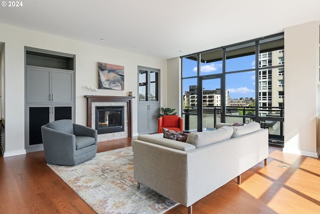 living room with wood-type flooring and a premium fireplace