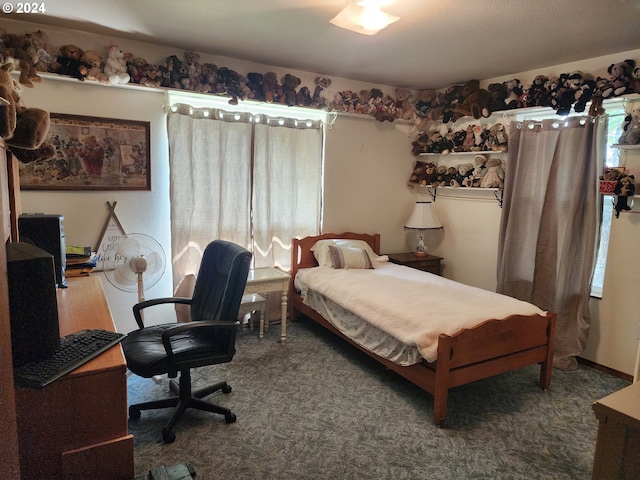 bedroom featuring dark carpet