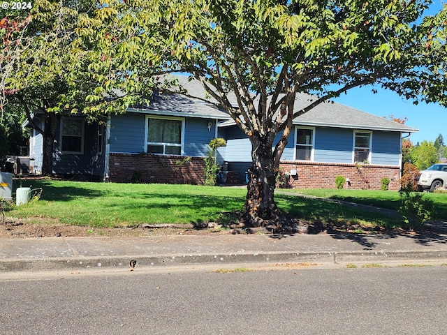 view of front facade with a front yard and a garage