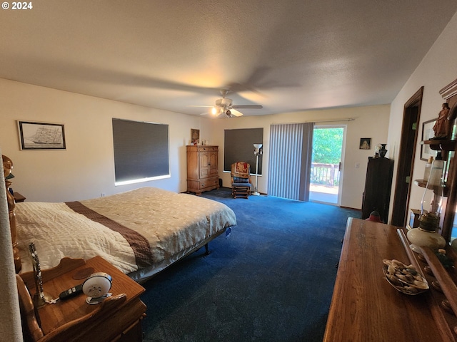 bedroom featuring ceiling fan, a textured ceiling, and dark colored carpet