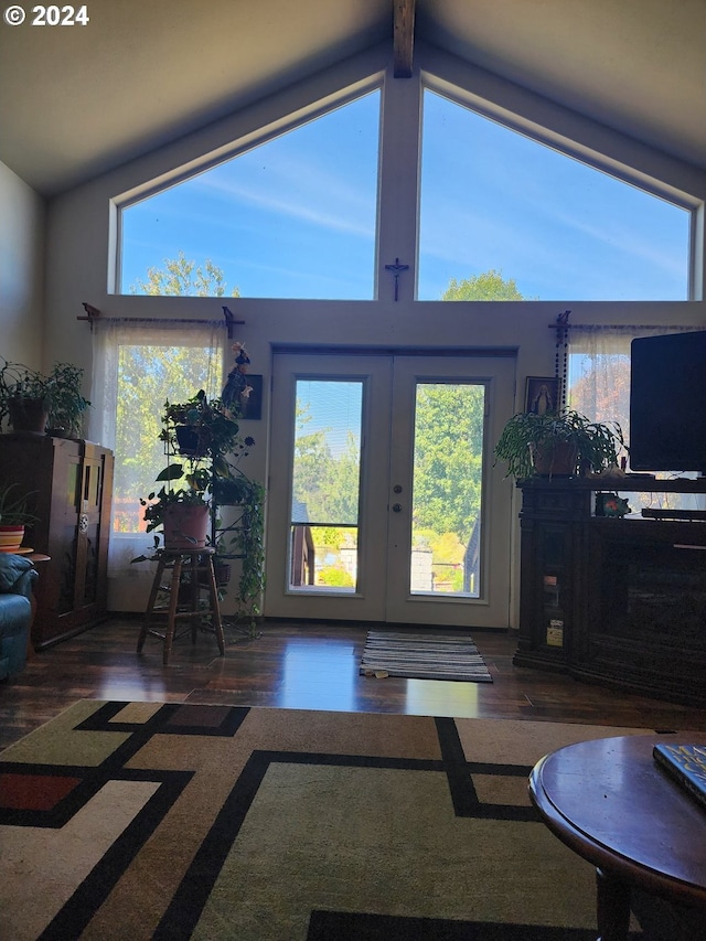 living room featuring high vaulted ceiling, beamed ceiling, dark hardwood / wood-style floors, and french doors