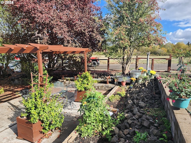 view of yard featuring fence and a garden