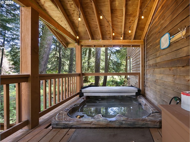 wooden terrace featuring a covered hot tub