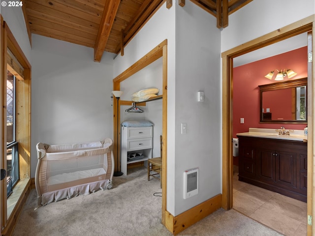 interior space with heating unit, sink, lofted ceiling with beams, and wooden ceiling