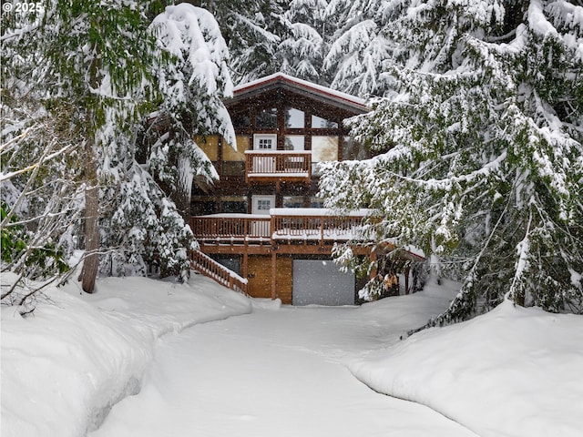 snow covered house with a deck