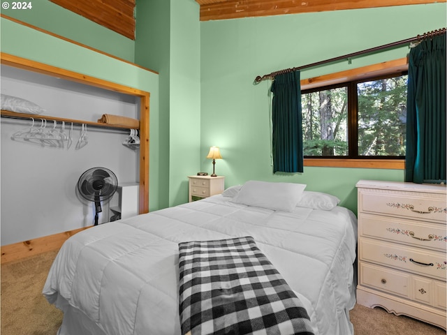 bedroom with light carpet and lofted ceiling