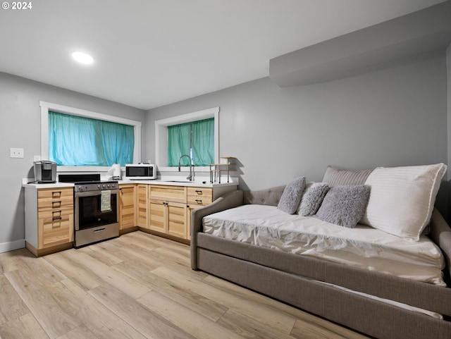 88940 E Round Mountain Loop, Government Camp, OR 97028 - kitchen featuring stainless steel range with electric cooktop, white microwave, light brown cabinets, light wood finished floors, and recessed lighting