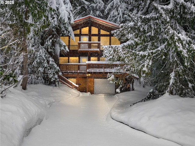 88940 E Round Mountain Loop, Government Camp, OR 97028 - snow covered rear of property with a balcony, an attached garage, and a wooden deck
