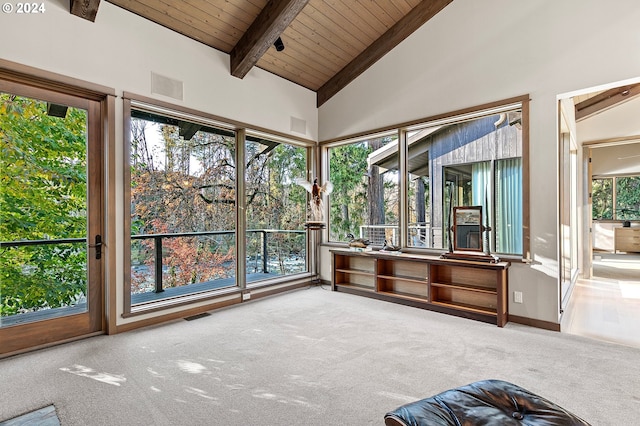 unfurnished sunroom featuring vaulted ceiling with beams, plenty of natural light, and wooden ceiling