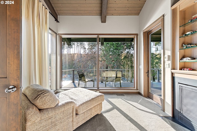 sunroom featuring beam ceiling and wooden ceiling