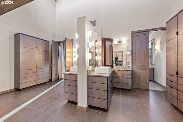 45650/45646 Mckenzie Hwy, Vida, OR 97488 - bathroom with tile patterned flooring, two vanities, baseboards, and a high ceiling