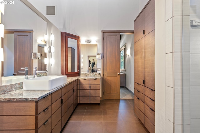 bathroom with tile patterned floors and vanity