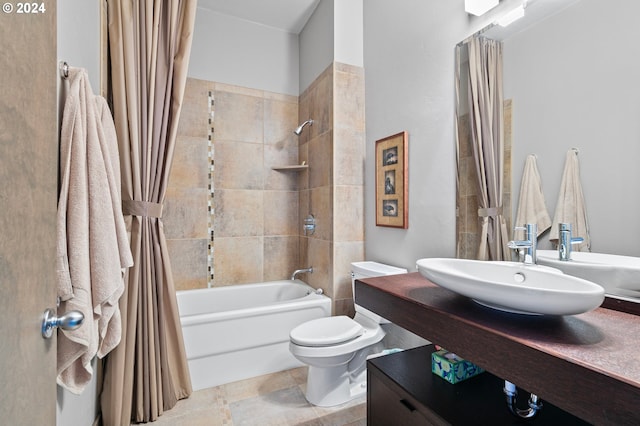 full bathroom featuring sink, shower / bathtub combination with curtain, and toilet