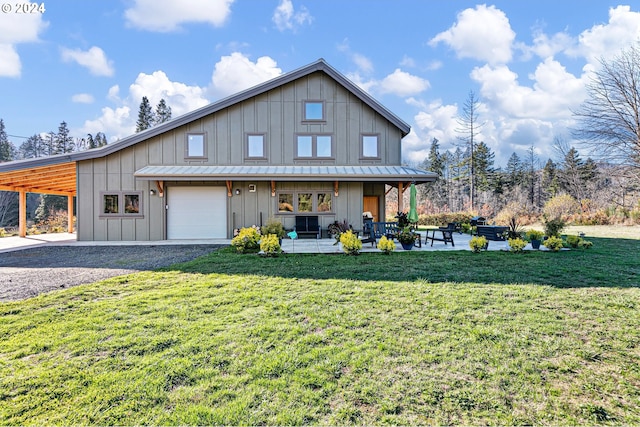 view of front of property featuring a carport, a garage, and a front lawn