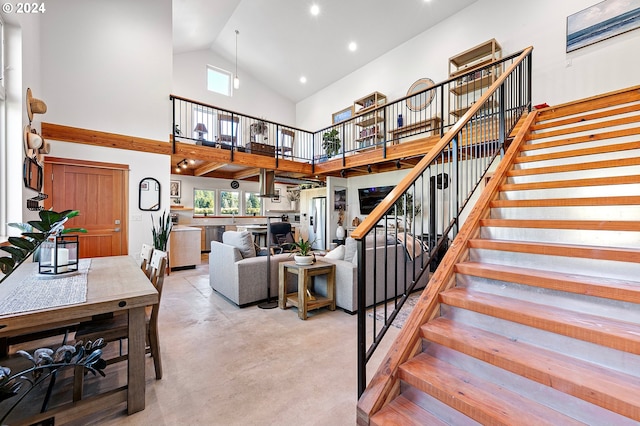 living room with high vaulted ceiling