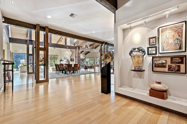 interior space featuring rail lighting and light hardwood / wood-style floors