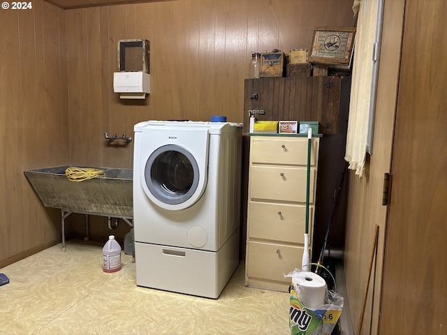 laundry area with washer / dryer, laundry area, and wood walls