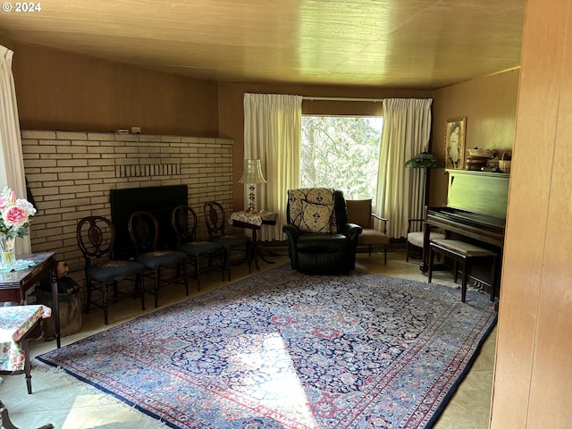 sitting room with a brick fireplace