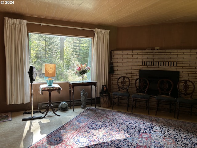 living area featuring wooden ceiling and a brick fireplace