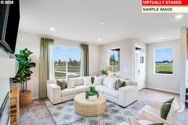 living area featuring recessed lighting and baseboards