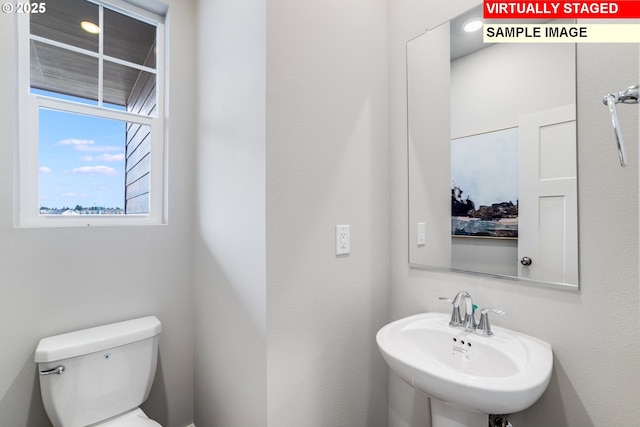 bathroom with toilet and a sink