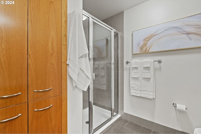 bathroom with tile patterned floors and an enclosed shower