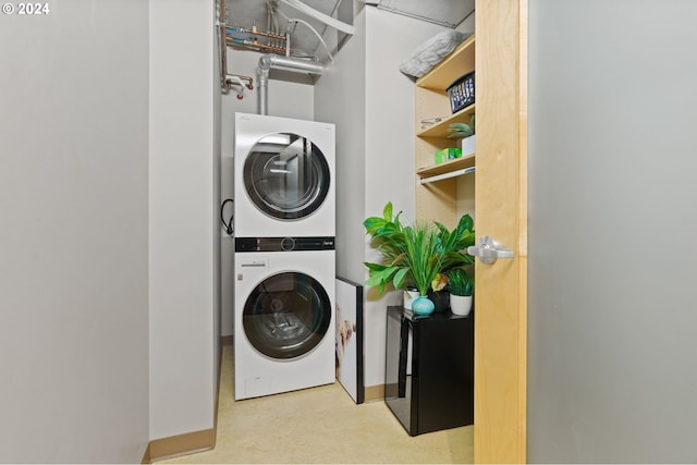 laundry area featuring stacked washer and clothes dryer