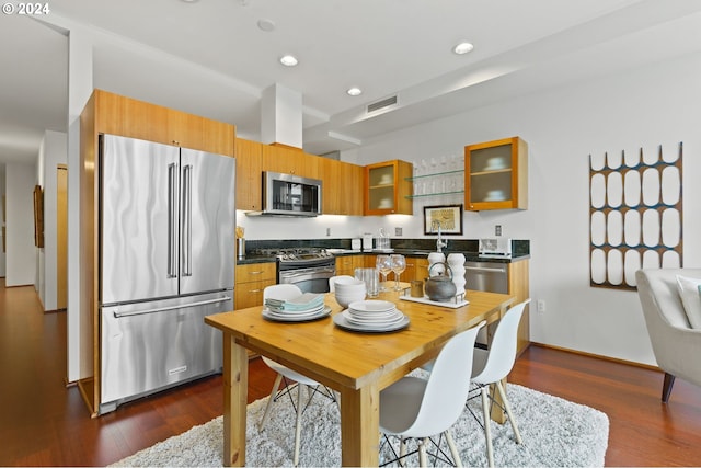 kitchen featuring dark wood-type flooring, stainless steel appliances, and sink