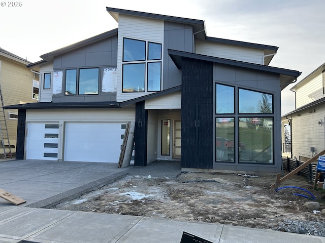 rear view of house with a garage