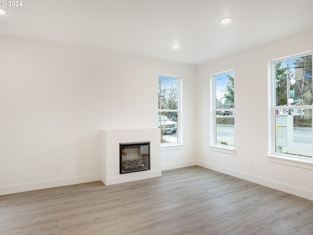 unfurnished living room with light hardwood / wood-style floors