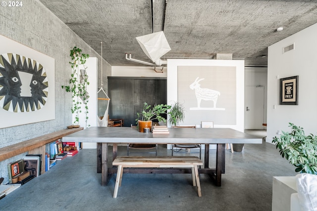 dining area featuring concrete flooring